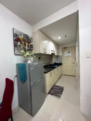 a kitchen with a stainless steel refrigerator in a room at Staycation Near Moa by Jen in Manila