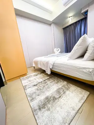 a bedroom with a bed and a rug at Ultra Luxury 1BR near Solaire & Okada in Manila