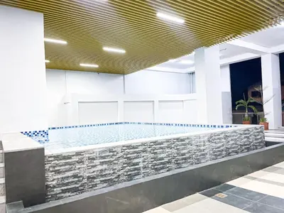 a pool in the lobby of a building at Luxury Penthouse near Solaire, City of Dreams in Manila