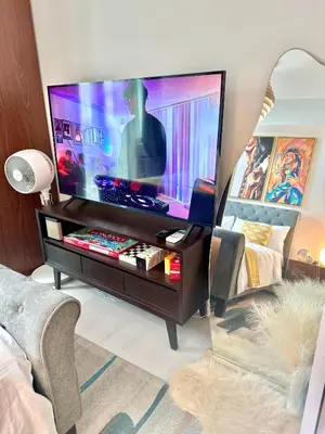 a living room with a large flat screen tv at Cityscape Staycation by H&B in Manila