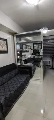 a living room with a couch and a mirror at Moana's Place Staycation in Manila