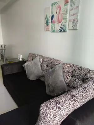 a couch with pillows on it in a room at LDN TWO Palm Tree Newport City in Manila
