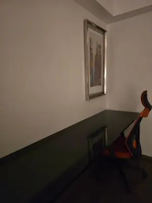 a room with a chair and a picture on the wall at The Imperium Luxury Condominium in Manila