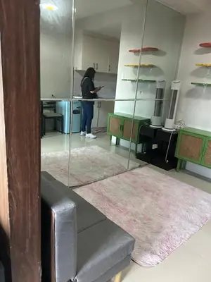 a woman standing in a room with a mirror at Chay place sea residence in Manila