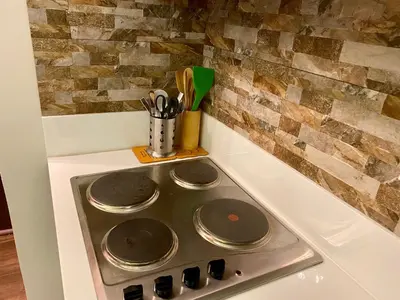 a stove top with four burners on it in a kitchen at Air Residence Luxury condo in Manila