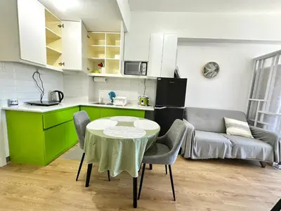 a kitchen and a table in a room at South Residences Tower in Manila