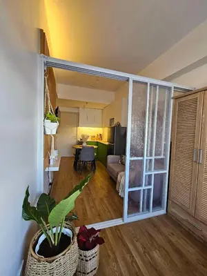 a living room with a door open to a living room at South Residences Tower in Manila