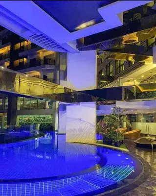 a large building with a large swimming pool at Maleel Rentals in Manila