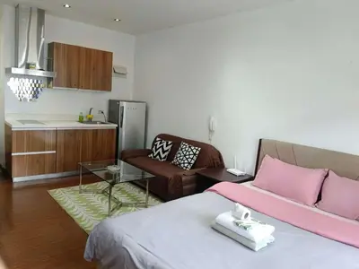 a living room with a bed and a couch at Maleel Rentals in Manila