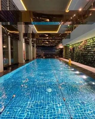 a large swimming pool in a large building at Maleel Rentals in Manila