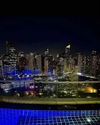 a view of a city at night with blue lights at Maleel Rentals in Manila