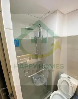a bathroom with a toilet and a glass window at Stunning Hotel Feels at Shore in Manila