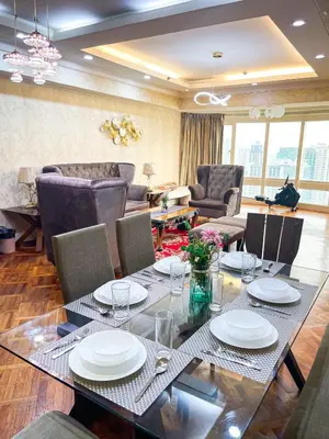 a living room with a dining table and chairs at Stunning & Luxury 4BR in Manila Bay White Beach in Manila