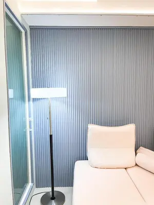 a room with a bed and a floor lamp at Lovely Penthouse across City of Dreams, Airport in Manila