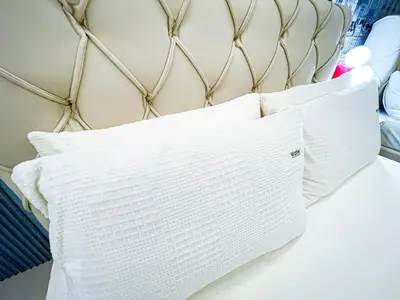 a bed with two white pillows on it at Lovely Penthouse across City of Dreams, Airport in Manila