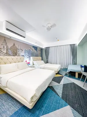 a hotel room with two beds and a desk at Lovely Penthouse across City of Dreams, Airport in Manila