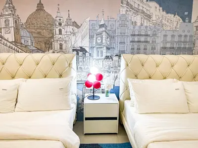 a bedroom with two beds and a mural of a city at Lovely Penthouse near Airport, City of Dreams 8pax in Manila