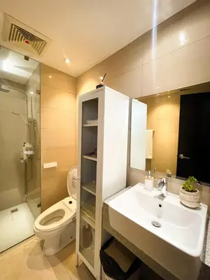a bathroom with a sink and a toilet at Lovely & Modern 1BR in Manila across Okada in Manila