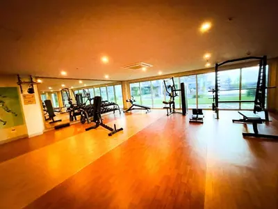 a gym with treadmills and machines in a room at Lovely & Modern 1BR in Manila across Okada in Manila