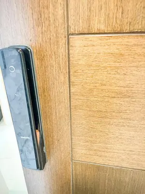 a close up of a door handle on a wooden door at Luxury 2BR beside Okada Manila in Manila