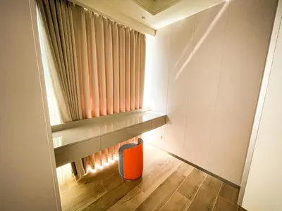 a small room with a window and an orange chair at Luxury 2BR beside Okada Manila in Manila