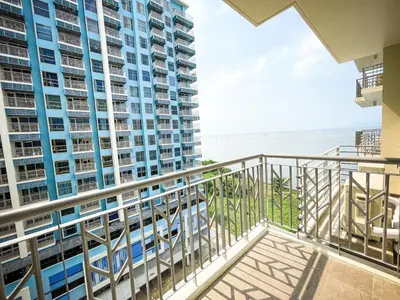 a balcony with a view of the beach and buildings at Luxury 2BR beside Okada Manila in Manila