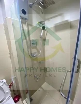 a shower stall in a bathroom with a toilet at Serene Suite at Shore 3 in Manila