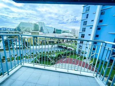 a balcony with a view of a river and buildings at Luxury 2BR Corner near Solaire & Okada II Sunset in Manila