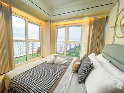 a bedroom with a large bed with a large window at Modern Luxury 5BR Sunset View beside Okada Manila in Manila