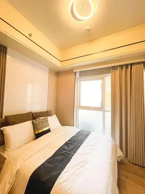 a bedroom with a large bed with a window at Modern Luxury 5BR Sunset View beside Okada Manila in Manila