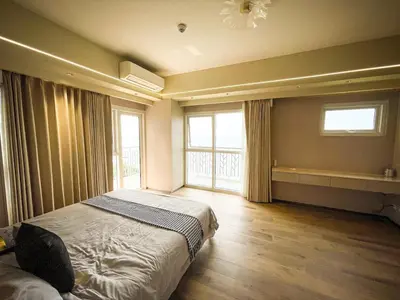 a bedroom with a bed and a large window at Luxurious 3BR in Manila Bay across Okada II 12pax in Manila