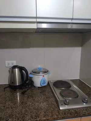 a kitchen counter with a tea pot and a tea kettle at Two Palm Tree Villas by Nadz6 in Manila