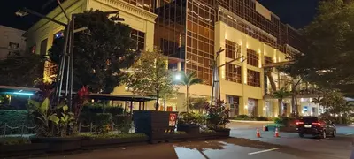 a car parked in front of a building at night at Two Palm Tree Villas by Nadz6 in Manila