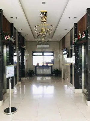 a large lobby with a chandelier in a building at Owls Nest Staycation in Manila