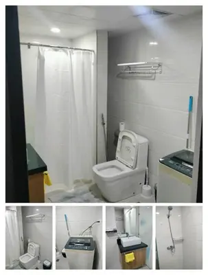 a bathroom with a white toilet and a shower at Manila Airport Accommodation at NAIA road in Manila