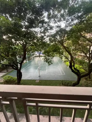 a tennis court in a park with trees at Arista Place Condo 2 bedroom unit in Manila