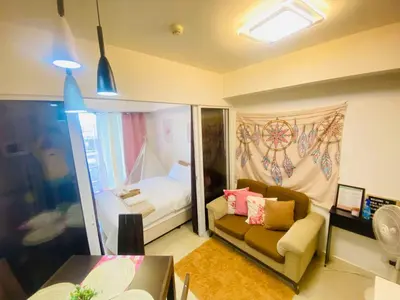 a small room with a couch and a bed at Sole Sisters Staycation in Manila