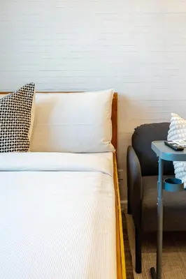 a bed in a room with a table and a chair at Best Condo in Makati Near Airport and FREE Parking! in Manila