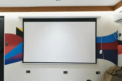 a large white screen on a wall with a painting at The Kin House - Stay in Art Poblacion in Manila
