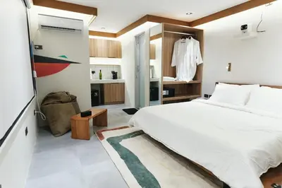 a bedroom with a large white bed in a room at The Kin House - Stay in Art Poblacion in Manila