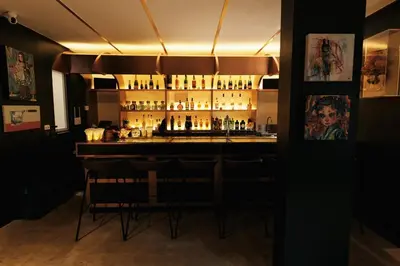 a bar with a lot of bottles of alcohol at The Kin House - Hotel in the Heart of Poblacion in Manila