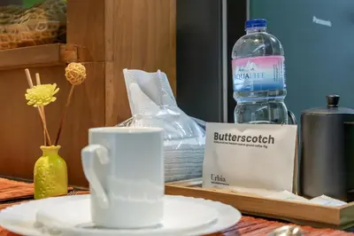 a table with a bottle of water and a cup at Relax & WFH in Vibrant & Cozy Greenbelt Condo with Pool in Manila