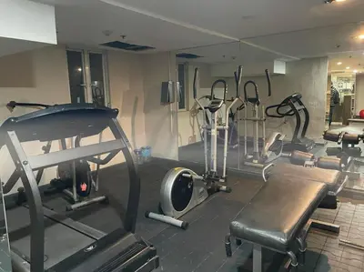 a gym with several exercise bikes and a treadmill at Charming Studio in Greenbelt Makati - Near Malls! in Manila