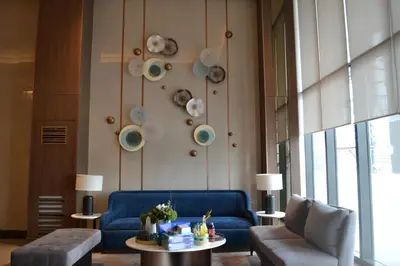 a living room with a blue couch and a table at Gentry Manor Pet Friendly Near MOA&NAIA Okada Complex 8T in Manila