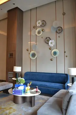 a living room with a blue couch and a table at Gentry Manor Manila Bay Okada Complex MOA&Airport WiFi Netflix 8K in Manila