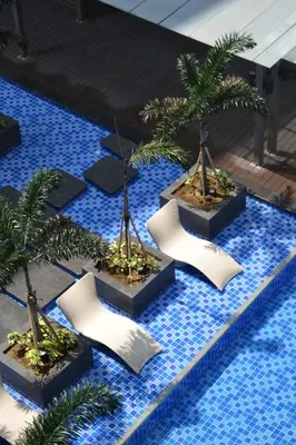 a group of palm trees in a swimming pool at Gentry Manor Manila Bay Okada Complex MOA&Airport WiFi Netflix 8K in Manila