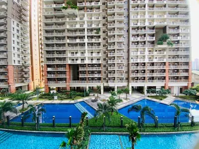 an aerial view of a large apartment building with two pools at Urban Resort District in Manila
