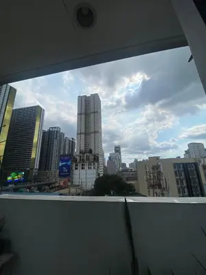 a view of a city skyline from a window at Ohana Buenbyahe Studio Rooms with balcony in Mandaluyong, Edsa Shaw Mrt and Megamall in Manila