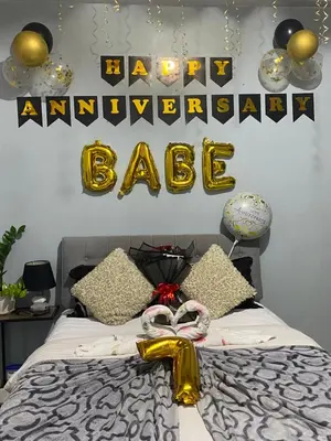 a bedroom with a bed with a happy anniversary bake sign at Nature Inspired Affordable Rooms in F RESIDENCE near Edsa Shaw Pasig Megamall Shangrila and MRT in Manila