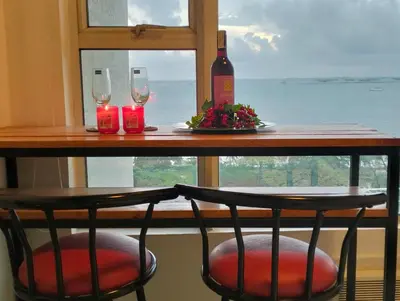 a table with two glasses and a bottle of wine at Chic Haven in Manila